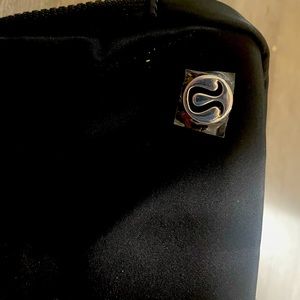Lululemon water repellent pouch . Adjustable strap .